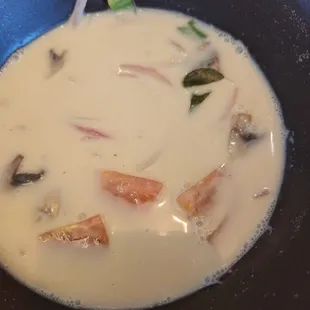 Tom ka soup with coconut soup and lemon grass .