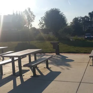 Tables and benches next to one of the BBQ grills.