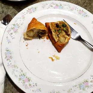 Veggie samosas cut open to see all the goodness inside.