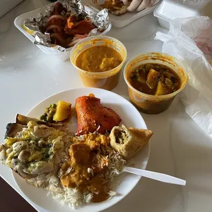 Rice with butter chicken, garlic naan, aloo matar, tandoori chicken and a veggie samosa.
