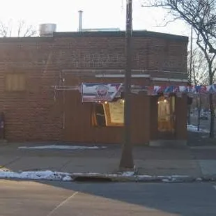 a corner of a brick building on a street corner