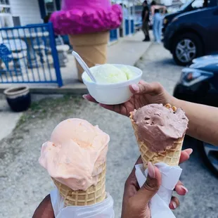 From the left orange pineapple cone, pistachio in the cup and chocolate truffle ice cream in the waffle cone.