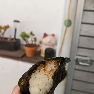 a person holding a piece of food