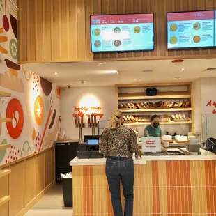 two people standing in front of a counter