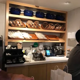 a man sitting at a counter in a bakery