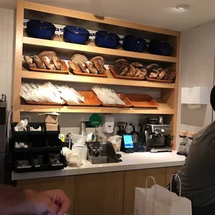 a man sitting at a counter in a bakery