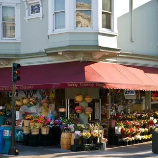 a flower shop on a street corner
