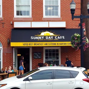 a white car parked in front of the restaurant