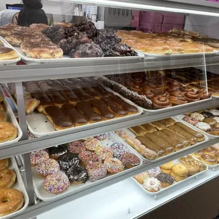 a variety of doughnuts in a display case