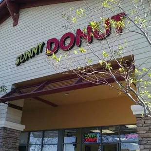 the front entrance of a donut shop
