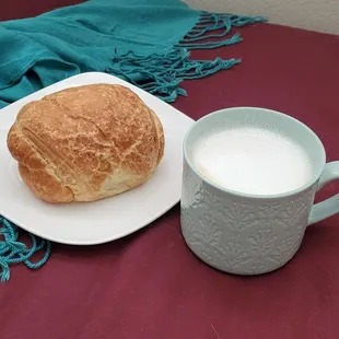 a bowl of milk and a plate of bread