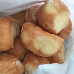 a pile of doughnuts in a paper bag