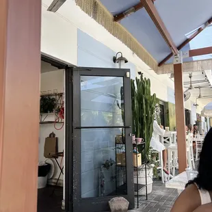 a woman sitting in a chair outside a restaurant