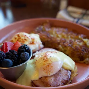 Eggs Benedict w/ Crispy Hash Brown | Lemon Hollandaise, Breakfast Ham, Paprika, Country Potato, Seasonal Fruit
