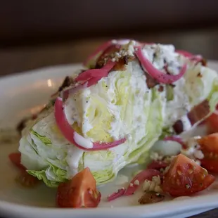 Chilled Wedge Salad | Iceberg, Blue Cheese Crumble, Campari Tomato, Red Onion, Croutons, Bacon, Fresh Black Pepper