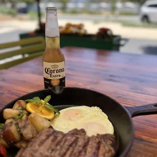 a steak and eggs in a skillet