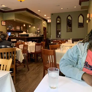 a woman sitting at a table in a restaurant