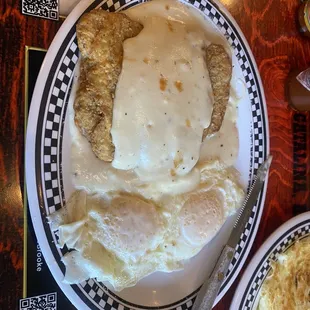 a plate of fried eggs and gravy