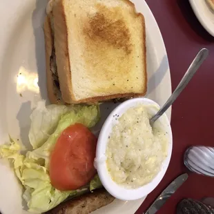 Chicken sandwich on toast and grits