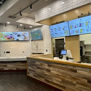 a restaurant counter with multiple screens