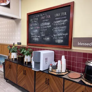 a coffee shop with a menu on the wall