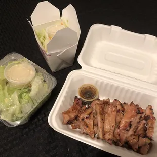 two take out containers with chicken and salad