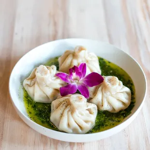 a bowl of dumplings and a flower