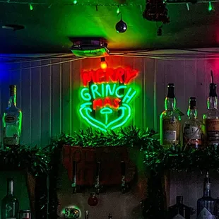 Grinch themed neon sign inside