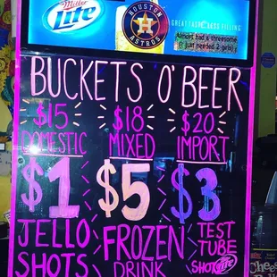 a neon sign with prices of beer