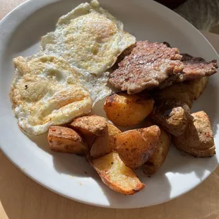 2 eggs (perfect over easy), potatoes with homemade sausage, a must!