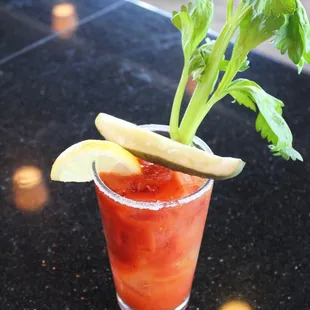 a bloody drink with a garnish