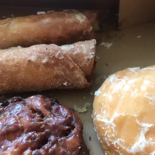 Fried tortilla confections on the top left: one is berry the other is apple cinnamon. Also pictured is an apple fritter and a lemon filled.