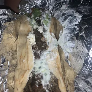 a steak sandwich wrapped in foil