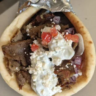 Our Classic Gyro sandwich, wrapped in pita bread and topped with feta cheese and Tatzkiki