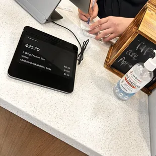 a woman sitting at a desk with a tablet computer