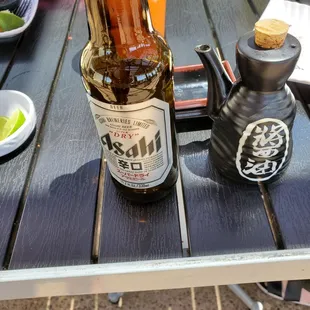 a bottle of sushi on a picnic table
