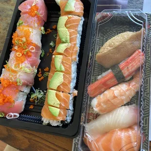 two trays of sushi on a table