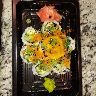 a plate of sushi on a granite countertop