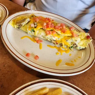 a slice of omelet and french fries