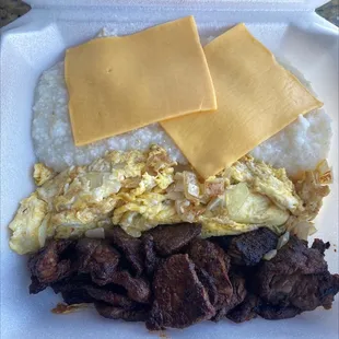 2 eggs, steak, grits, and toast