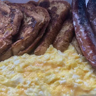 a plate of eggs, toast, and sausage