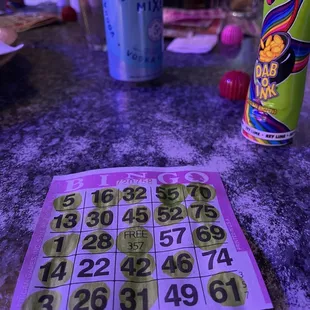 a bingo card and a can of soda