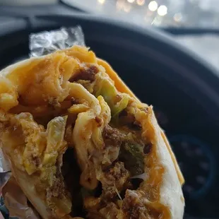 a hand holding a burrito