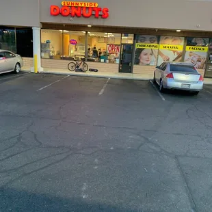 a car parked in front of a donut shop