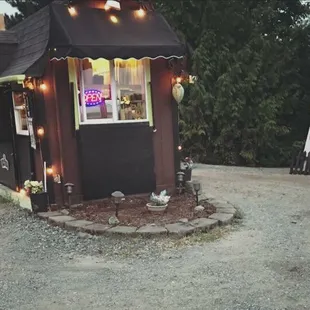 a small building with lights on it