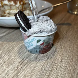 a cup of ice cream with an oreo sandwich