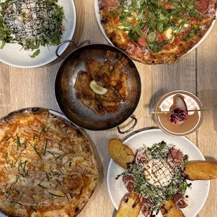 a variety of pizzas on a table