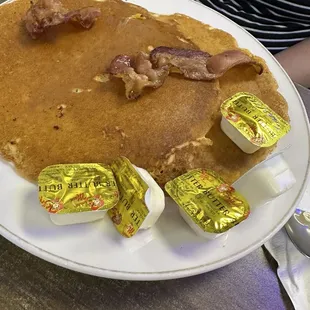 Pancakes and 2 slices of mediocre undercooked bacon