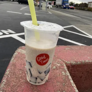 a cold drink in a plastic cup with a straw