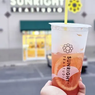 Grapefruit Jasmine, my chunky hand, Sunright Tea Studio in the background.